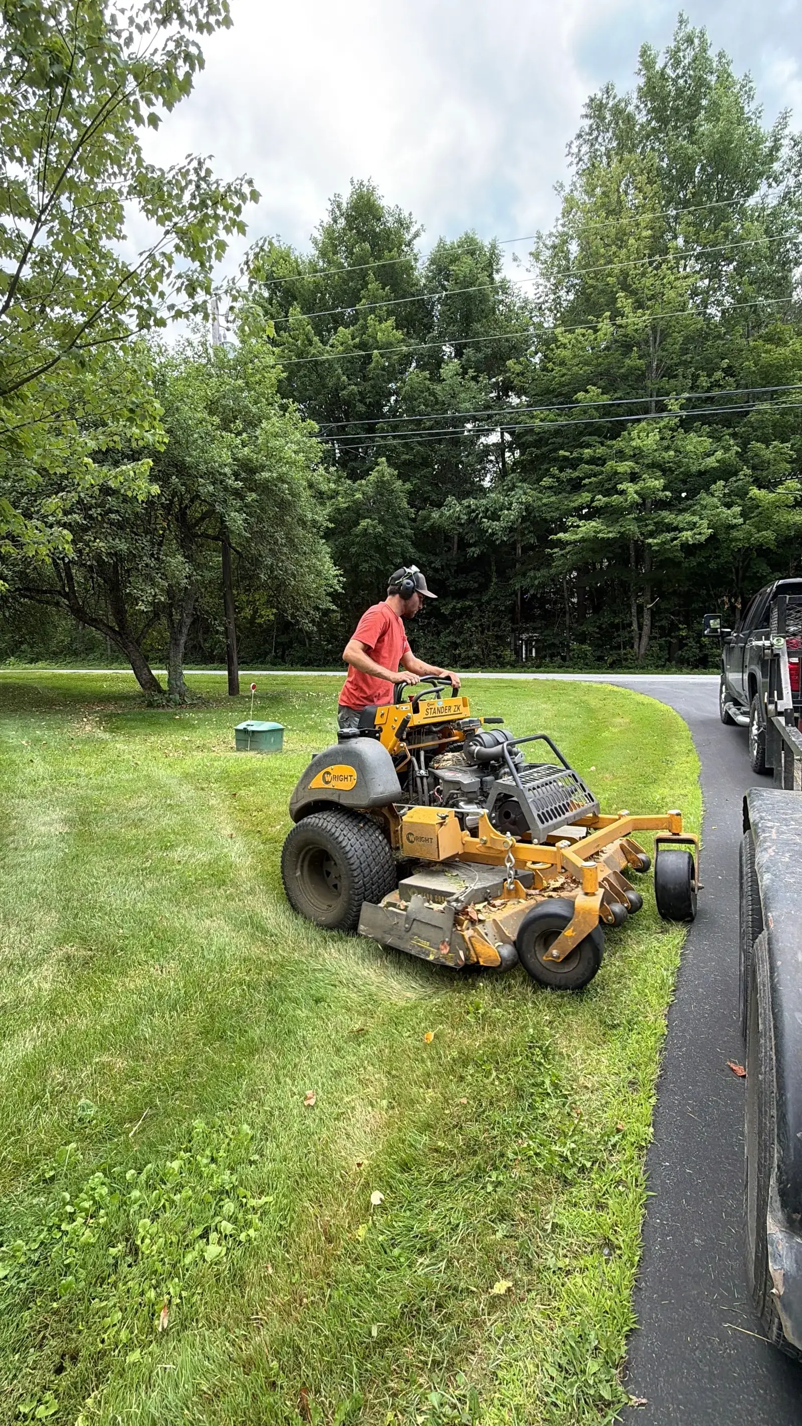 Mowing the grass strip along a paved driveway