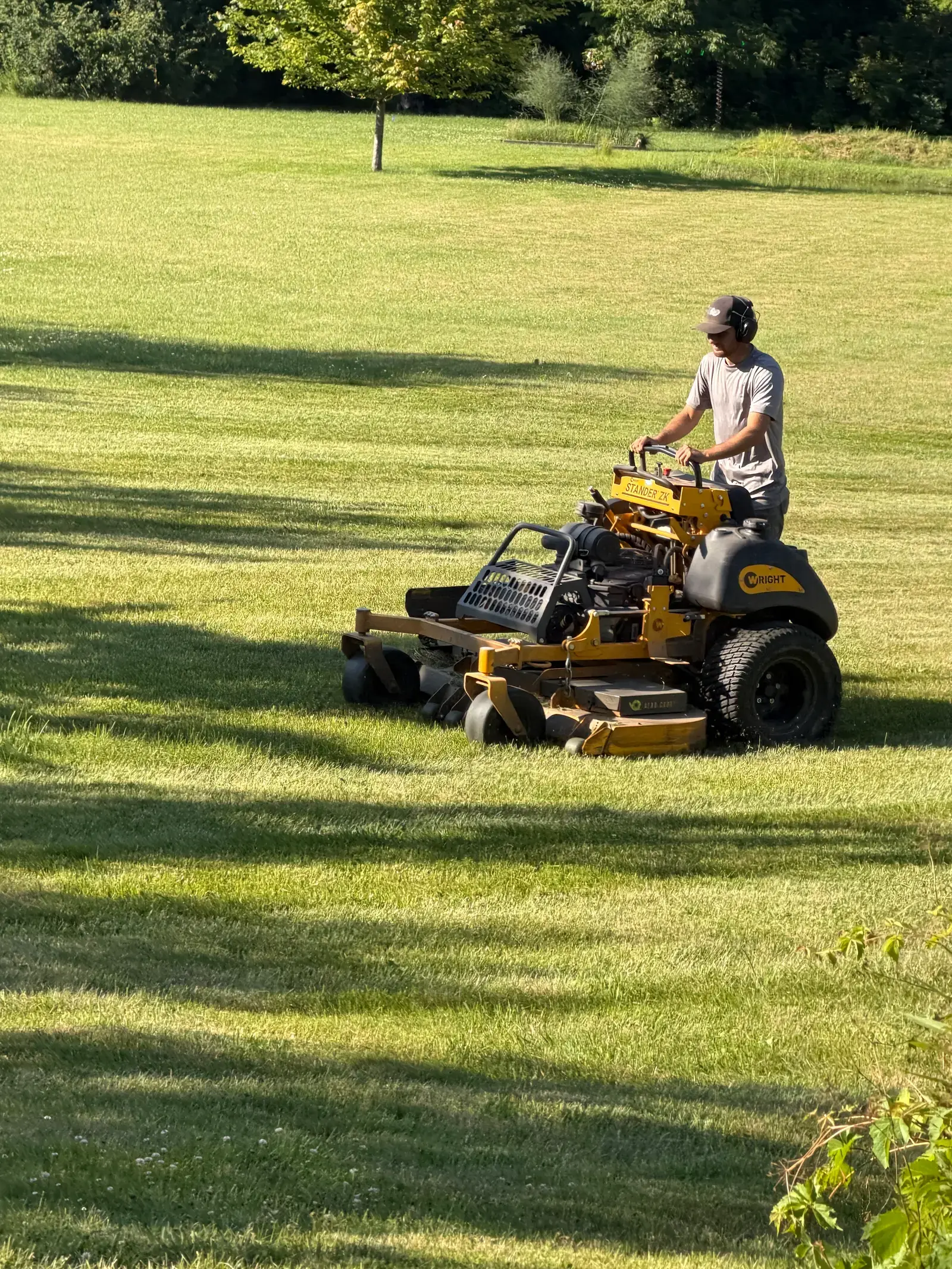 Mower working the edge of an open field